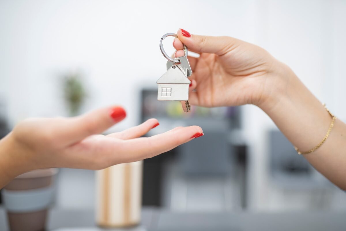 hands handing over keys for property purchase